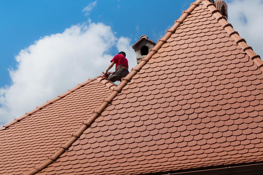 professional roofer working on roof repair